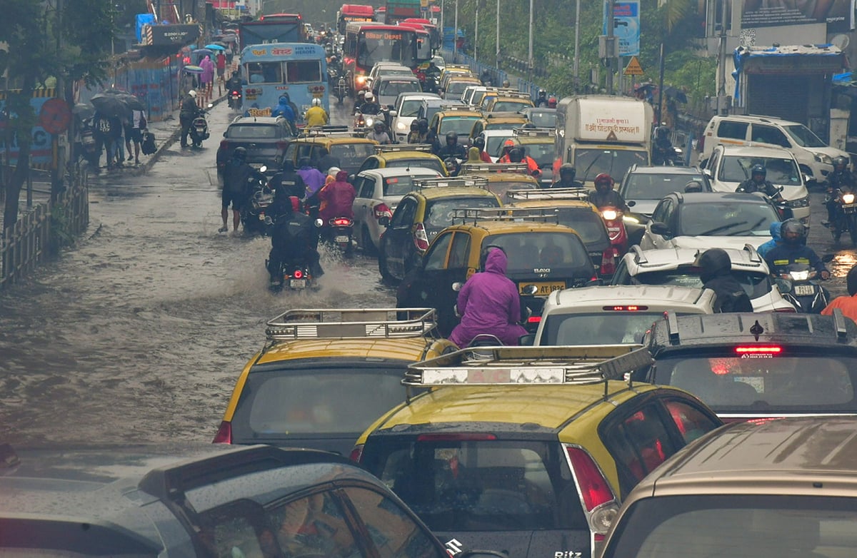 PTI : Vehicles move on a waterlogged road after heavy monsoon rain, at Dadar in Mumbai, Sunday, July 21, 2024. 